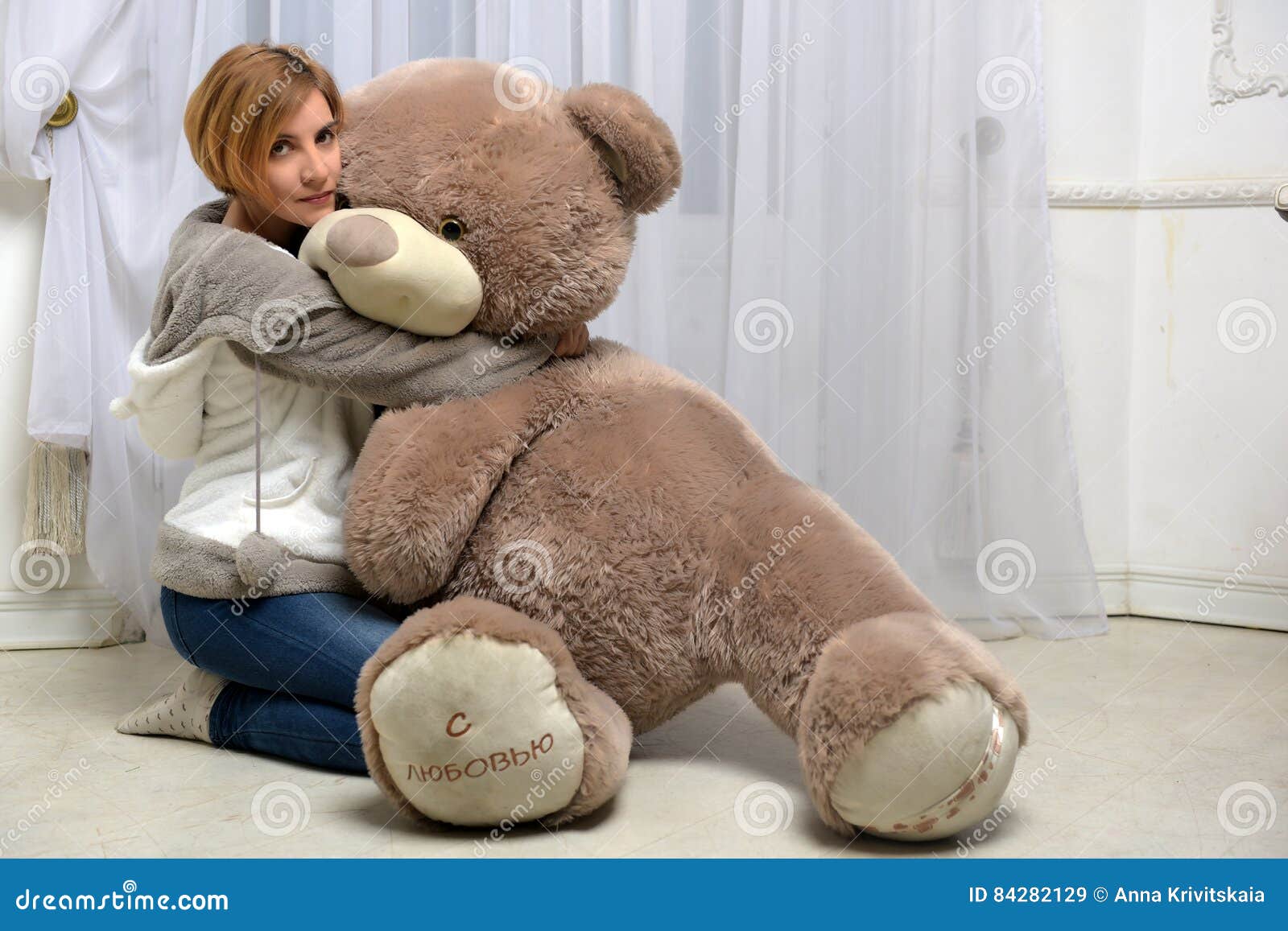 woman-hugs-big-toy-bear-84282129.jpg