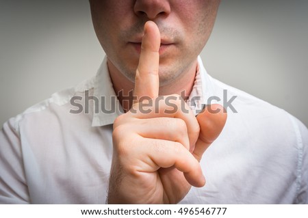 stock-photo-attractive-man-with-finger-on-lips-making-silence-gesture-shh-496546777.jpg