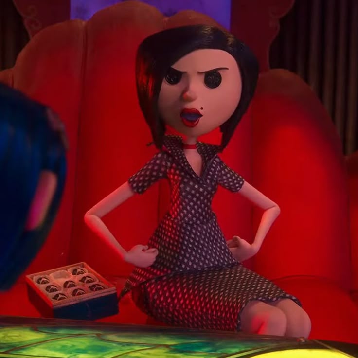 This may contain: an animated doll sitting on top of a red couch
