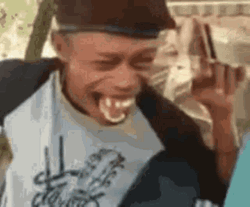 Guy Sitting And Laughing GIF | GIFDB.com