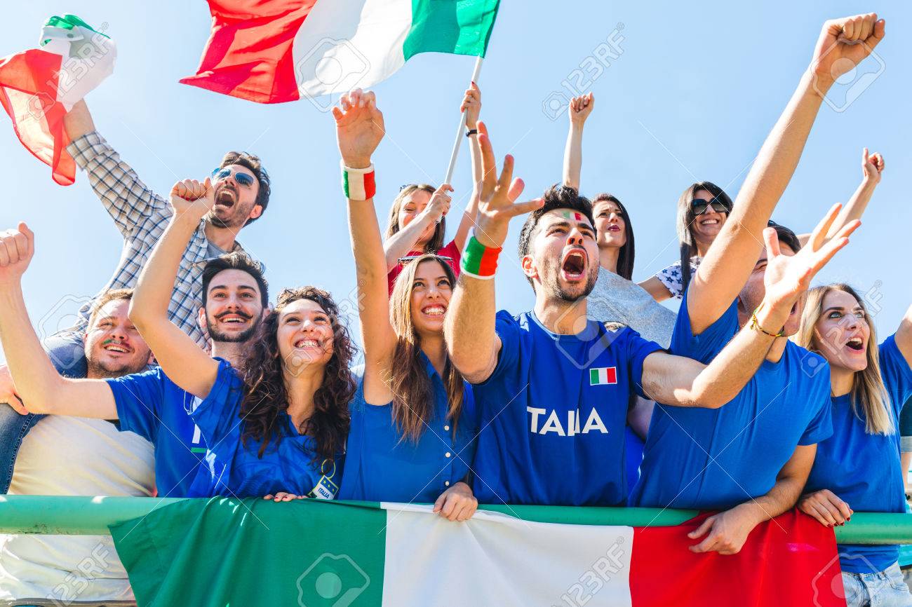 Italian supporters celebrating at stadium with flags. Group of fans watching a match and cheering team Italy. Sport and lifestyle concepts. Stock Photo - 86431576