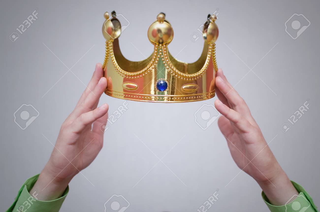 105147846-hands-holding-a-golden-crown-above-a-head-award-ceremony-of-winner-self-proclamation-concept-.jpg