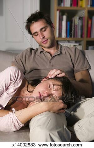 young-couple-on-sofa-woman-resting-stock-photo__x14002583.jpg