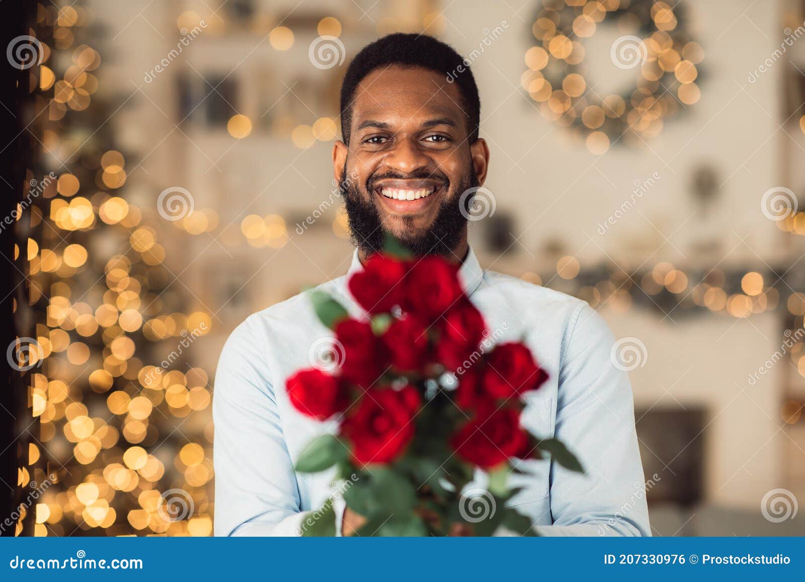 smiling-black-man-holding-roses-giving-to-camera-date-concept-portrait-happy-bearded-young-guy-bunch-fresh-flowers-bouquet-207330976.jpg