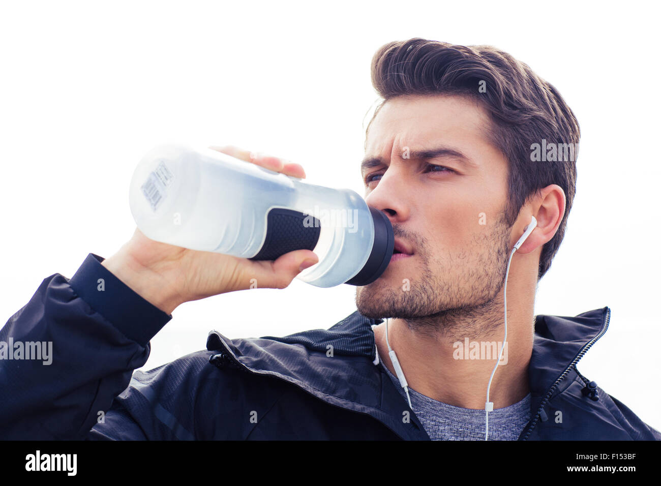 portrait-of-a-handsome-man-in-headphones-drinking-water-isolated-on-F153BF.jpg