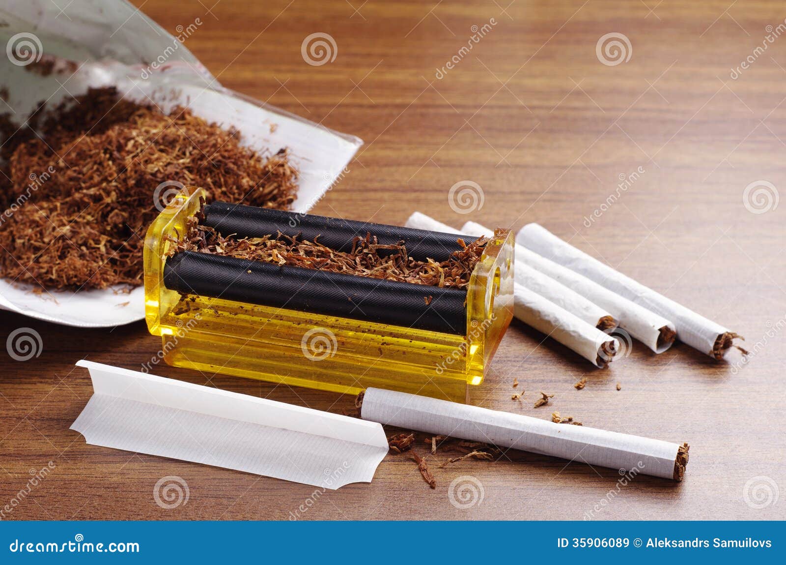 rolling-machine-cigarettes-brown-table-35906089.jpg
