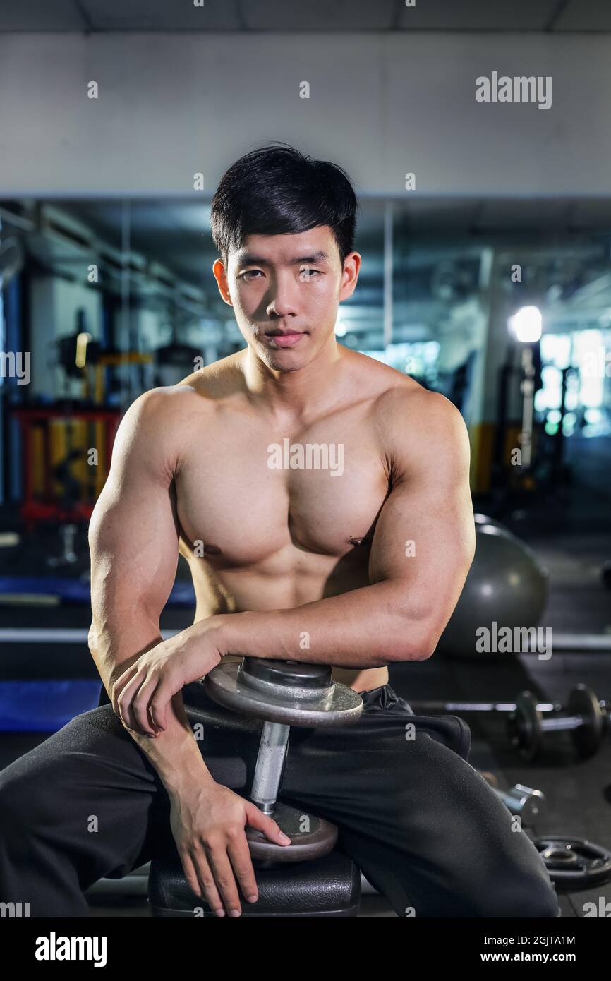 handsome-asian-man-with-dumbbell-in-the-gym-2GJTA1M.jpg
