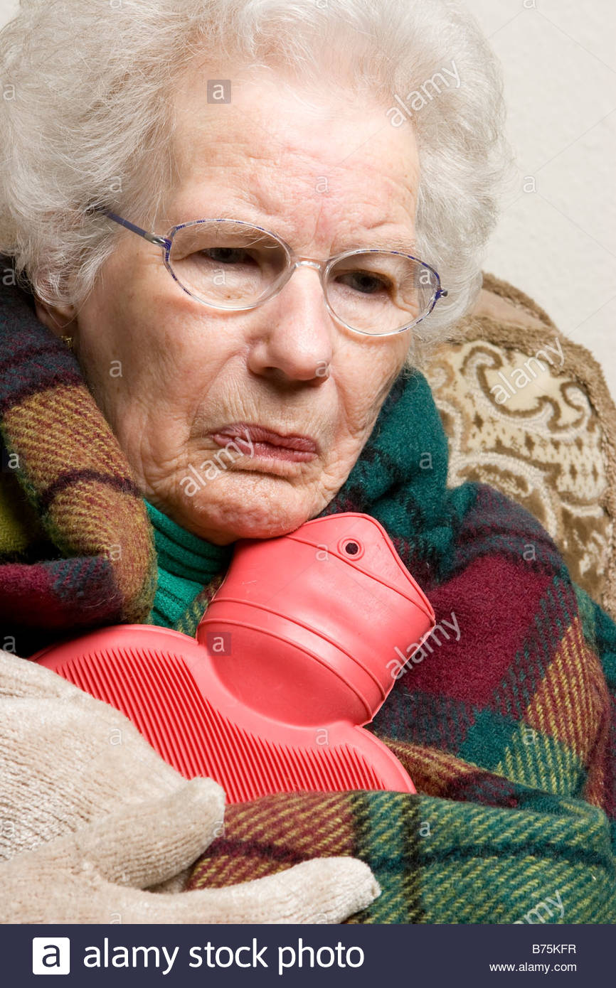 an-old-woman-holding-a-hot-water-bottle-B75KFR.jpg