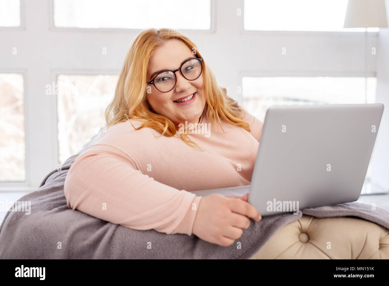delighted-fat-woman-sitting-with-her-laptop-MN151K.jpg