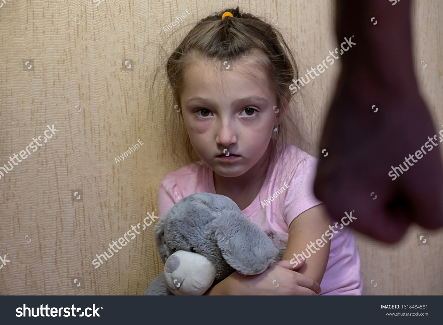 stock-photo-domestic-violence-concept-home-violence-girl-sitting-alone-leaning-on-the-wall-with-the-father-1618484581.jpg