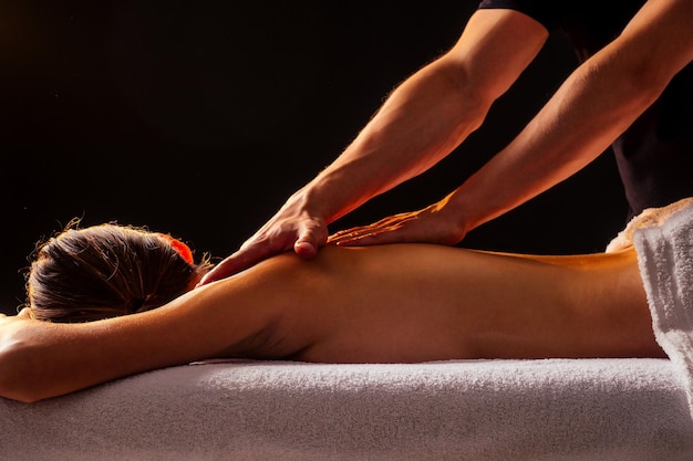 young-indian-woman-lying-table-getting-ayurvedic-massage-with-organic-oil-honeyed-dark-room-massagist-male-pouring-out-client-back_175356-4386.jpg