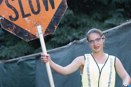 construction-woman-holding-slow-sign-picture-id123377745
