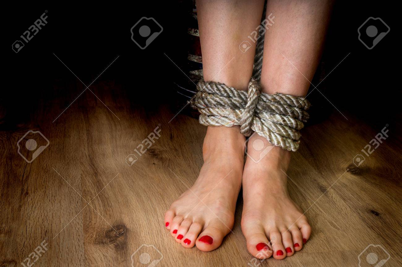 74227358-feet-of-a-victim-woman-tied-up-with-rope-violence-concept.jpg