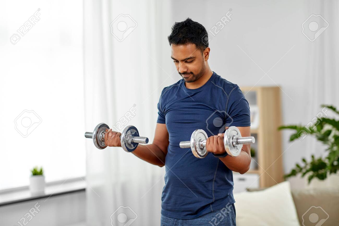 125557726-fitness-sport-weightlifting-and-bodybuilding-concept-indian-man-exercising-with-dumbbells-at-home.jpg