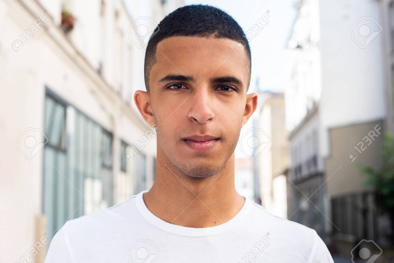 135316776-close-up-front-portrait-of-serious-young-north-african-man-with-serious-expression-in-the-city.jpg