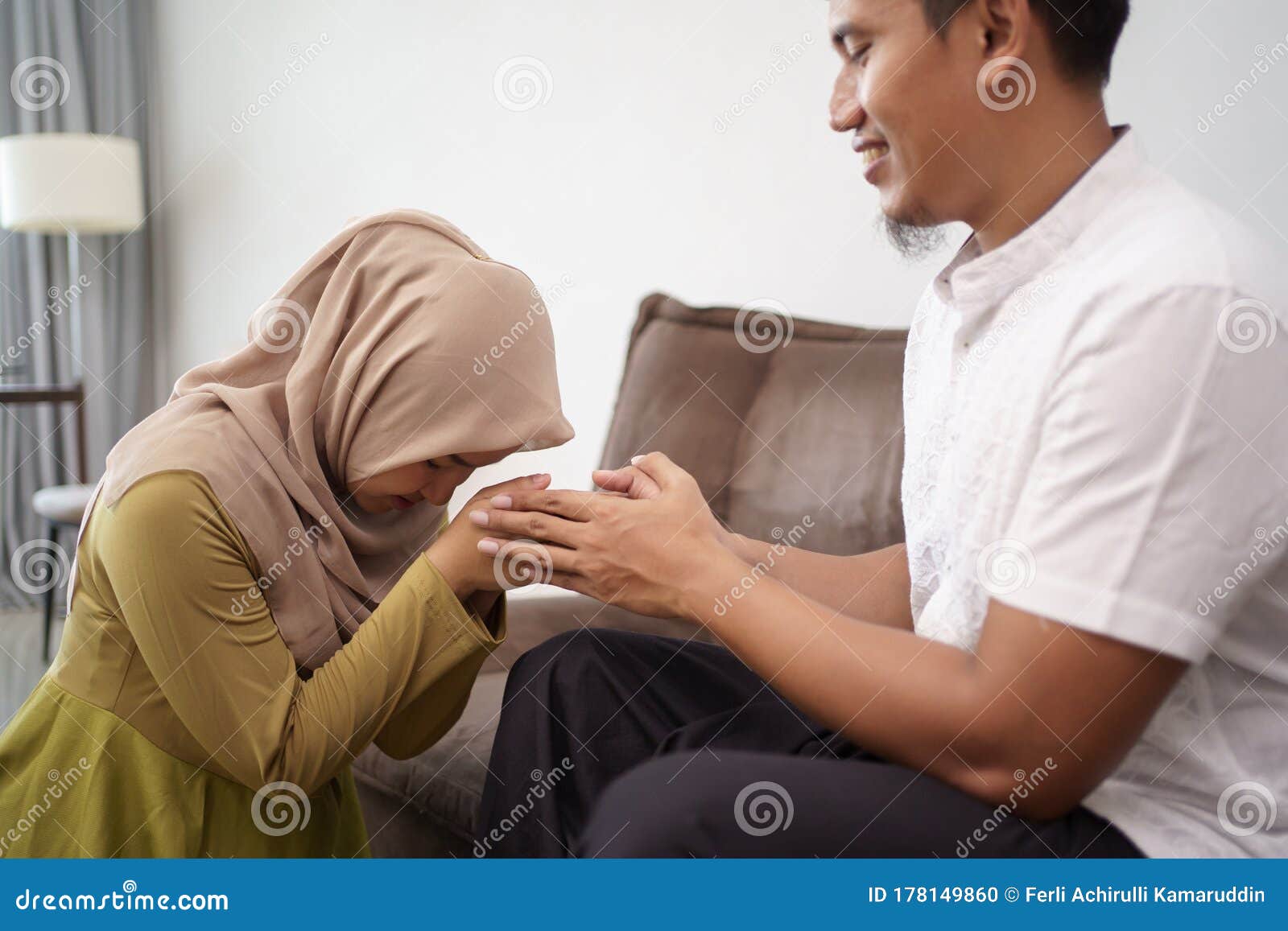 muslim-woman-apologizing-to-her-man-asian-women-men-hari-raya-eid-mubarak-shake-hand-kissing-178149860.jpg