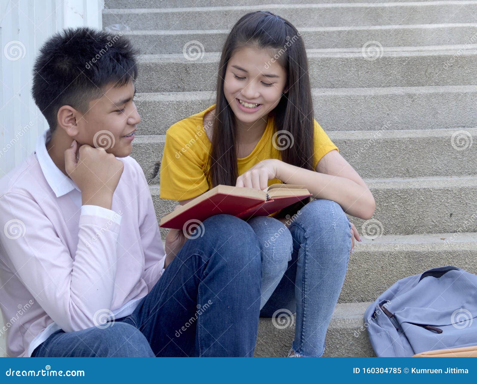 young-couple-sitting-stairs-school-teens-men-women-outdoor-backpacks-160304785.jpg