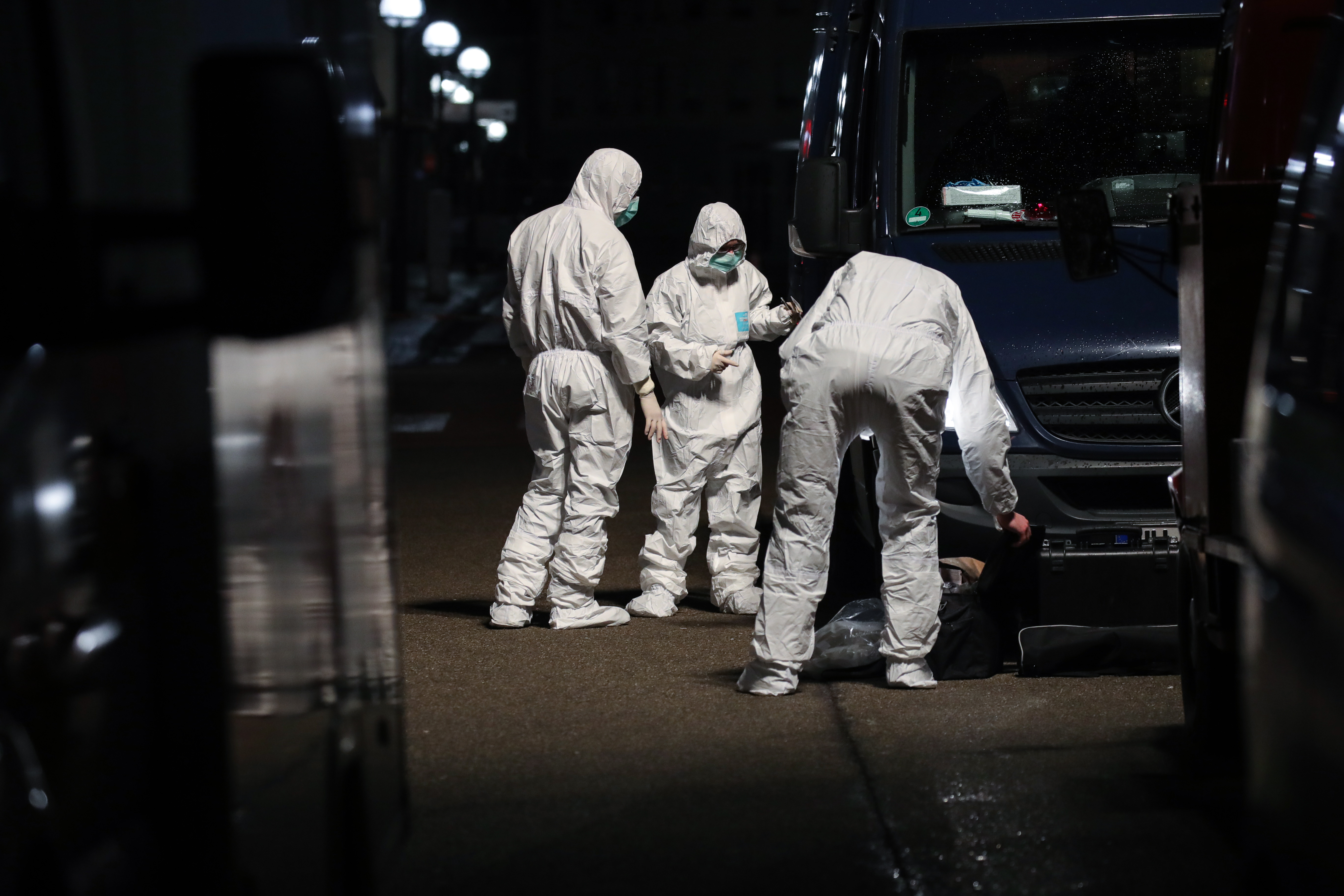  Forensic officers can be seen examining the scene