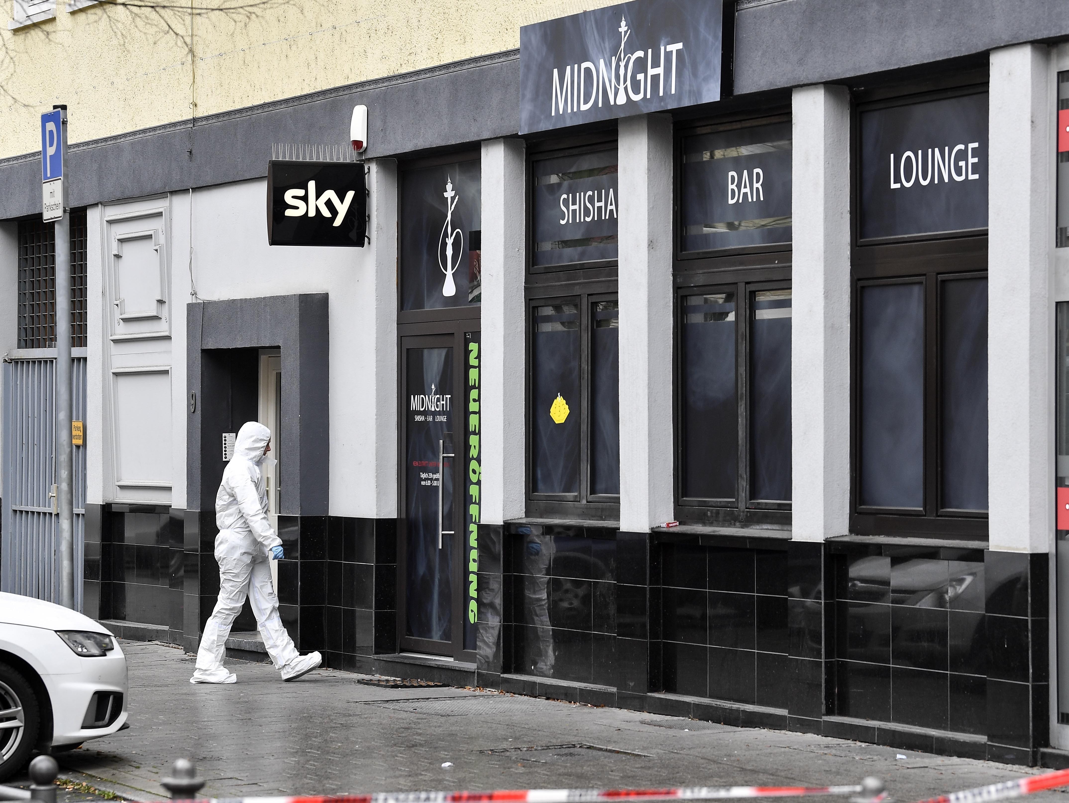  Police in hazmat suits secure the bar targeted in the attack